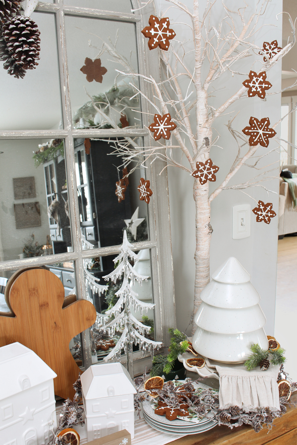 DIY Faux gingerbread snowflakes hanging from a tree on a Christmas sideboard.