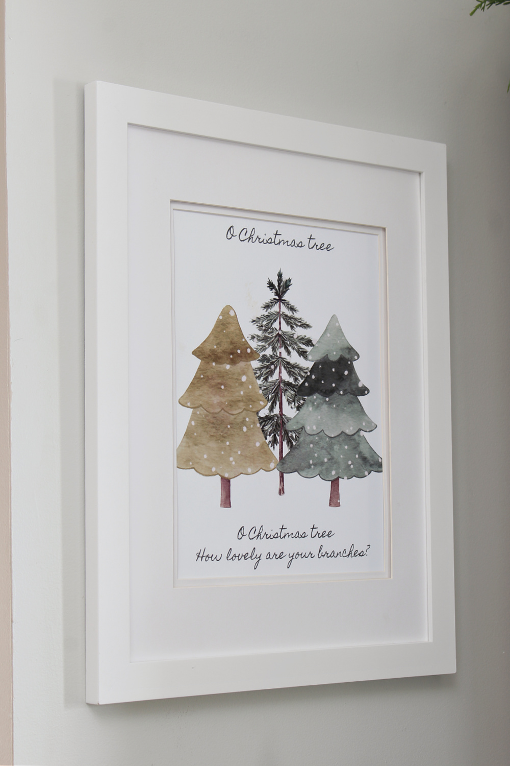 O Christmas Tree free Christmas printable hanging in a white frame.
