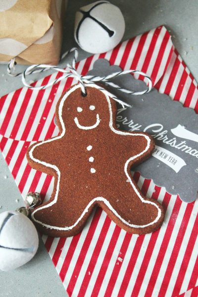 Cinnamon ornament gingerbread man used as a present topper.
