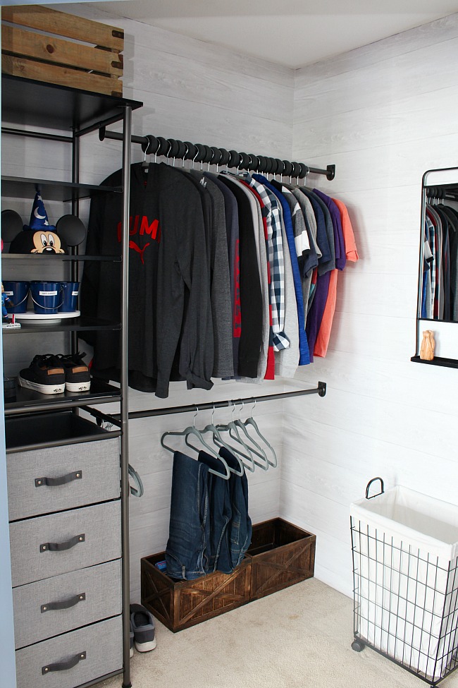 Awesome closet organizer system with a mix of open shelving and closed drawer space for storage. Double clothes rods for extra storage.