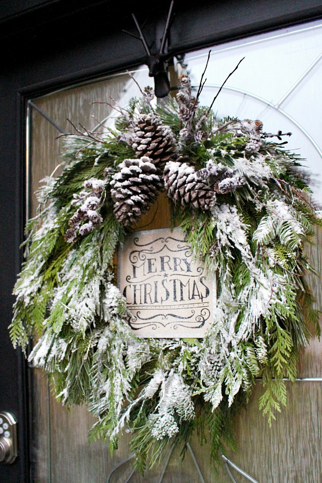 Christmas wreath made from fresh greenery and topped with flocking.