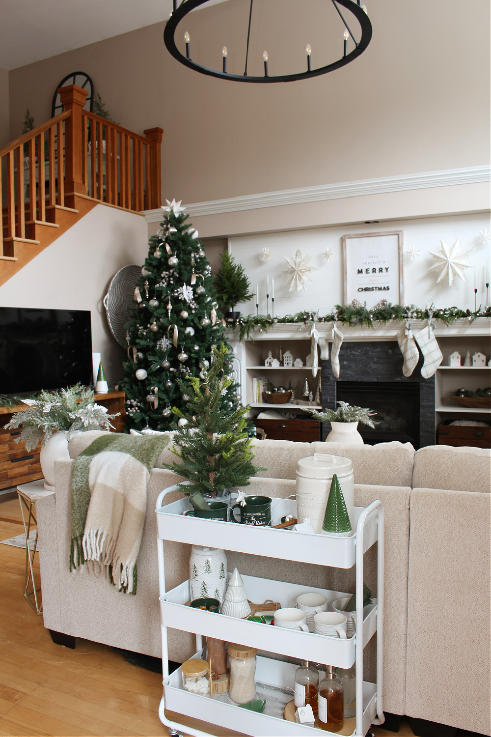 Cozy living room decorated for Christmas with white and green,