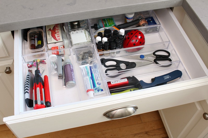 Kitchen junk drawer organized with acrylic bins.