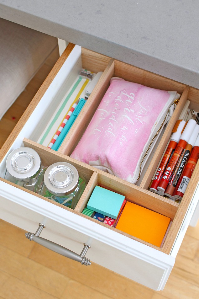 Organized desk drawer in a family command center.