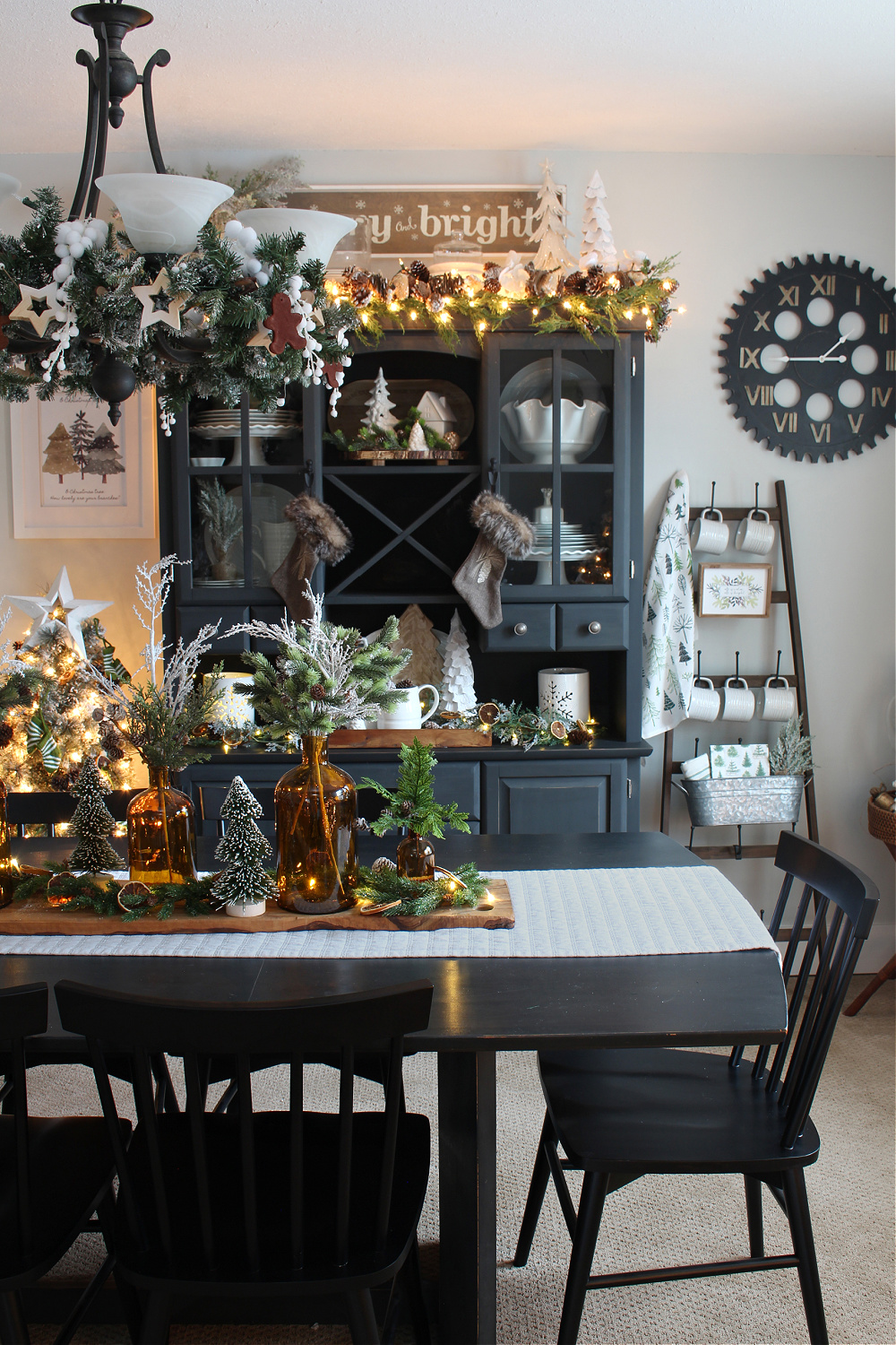 Christmas dining room with black furniture and Christmas lights.