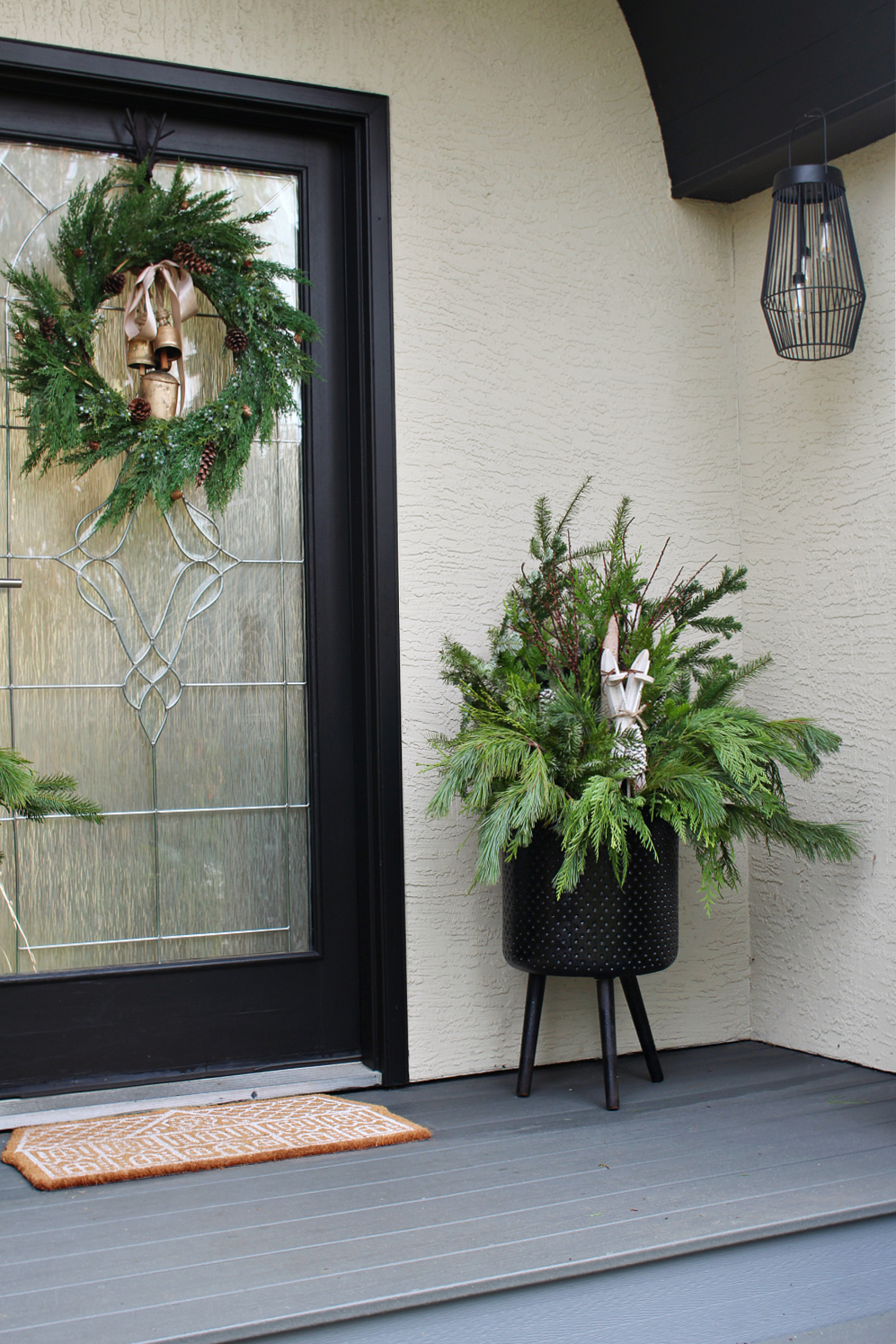 Christmas front porch with beautiful outdoor Christmas planters.
