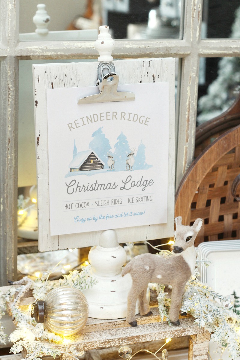 Reindeer Ridge Christmas Lodge free printable on a white clipboard frame with reindeer and twinkle lights.