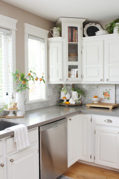 White kitchen decorated for summer with pops of orange.